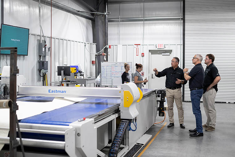 Image of Frank Hugelmeyer, Richie Rodgers and Russ Tomlinson taking a factory tour of the Sportsman Boats' facilities in South Carolina