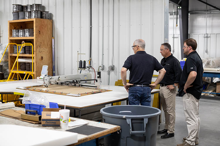 Image of Frank Hugelmeyer, Richie Rodgers and Russ Tomlinson taking a factory tour of the Sportsman Boats' facilities in South Carolina