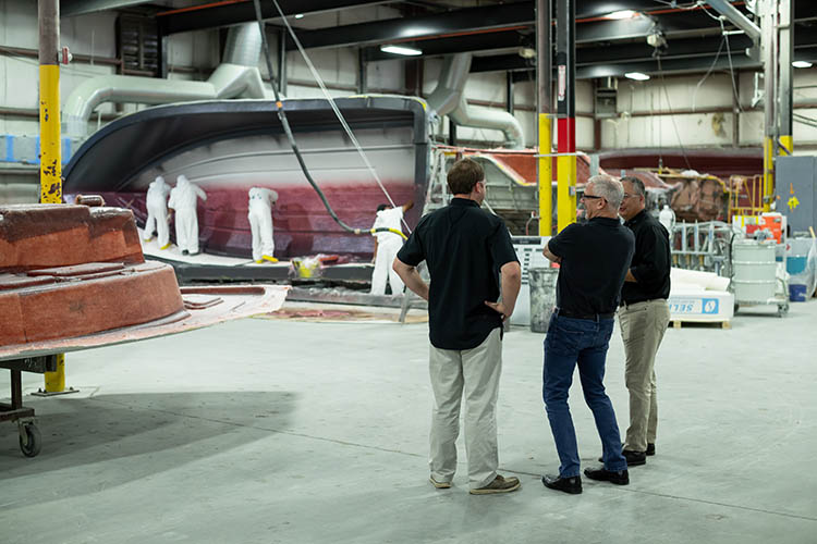 Image of Frank Hugelmeyer, Richie Rodgers and Russ Tomlinson taking a factory tour of the Sportsman Boats' facilities in South Carolina