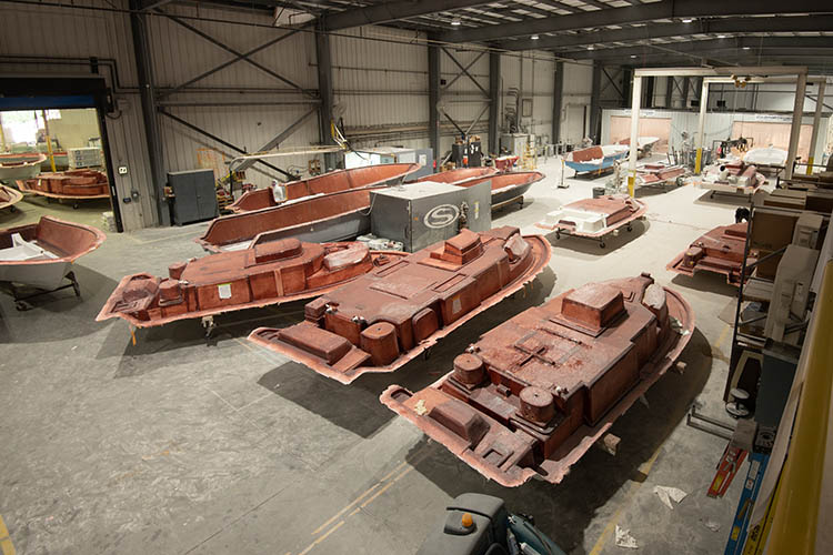 Decks and hulls making their way through lamination at our factory in Summerville, South Carolina
