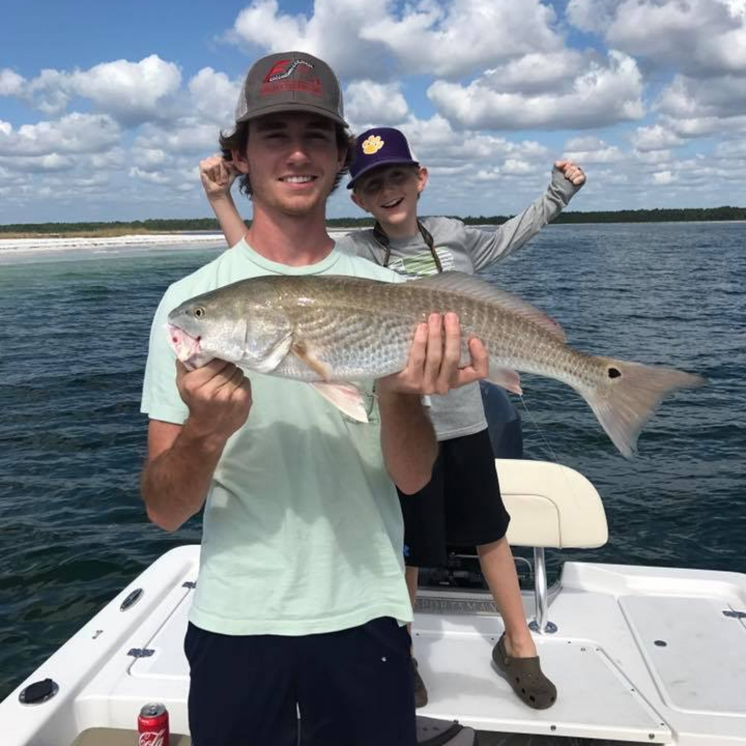 Nathan’s first legal redfish with a photo bomb by his brother.