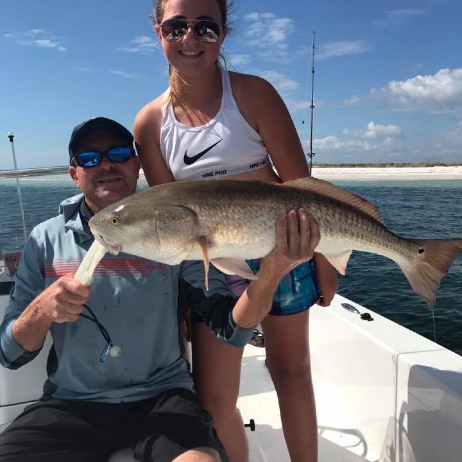 Katie with her first redfish showing her brothers how to catch bulls.