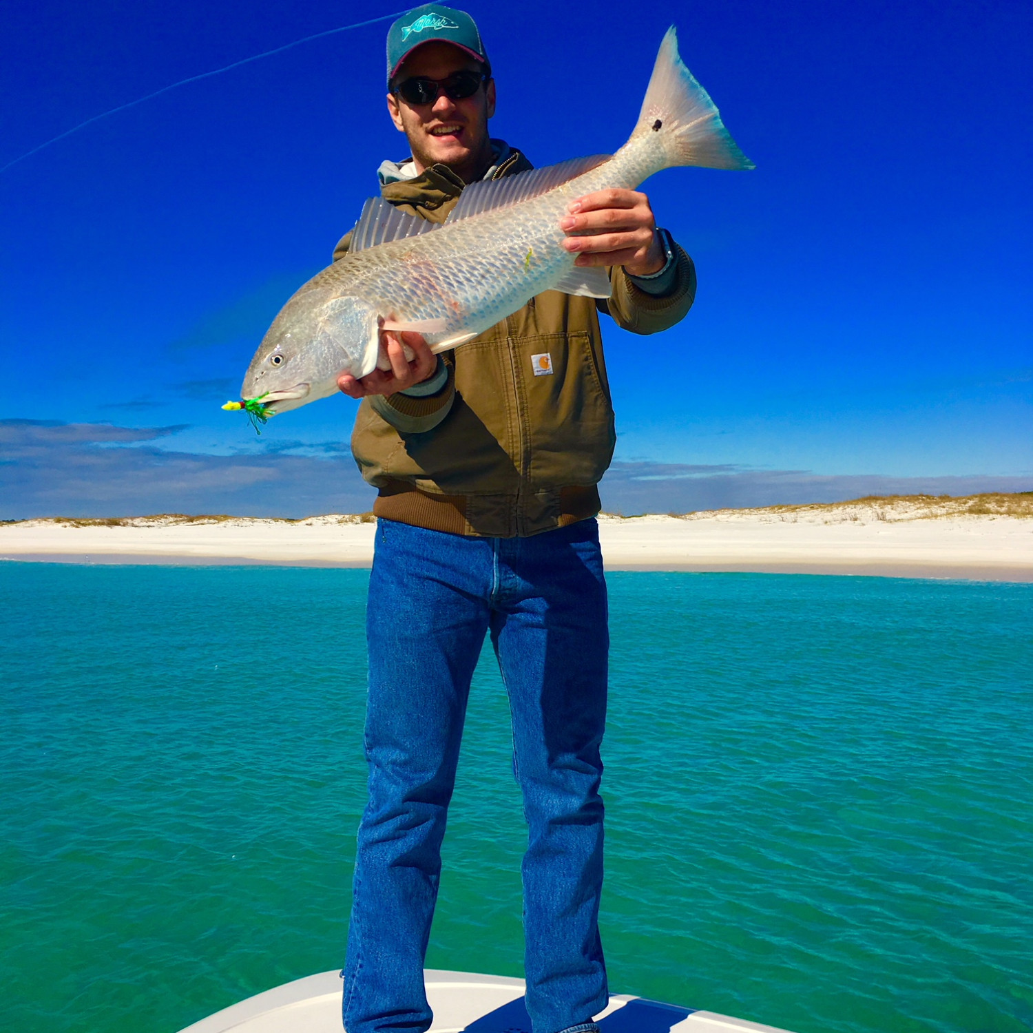 Over slot Redfish taken on a jig just off the beach on a beautiful winter day.