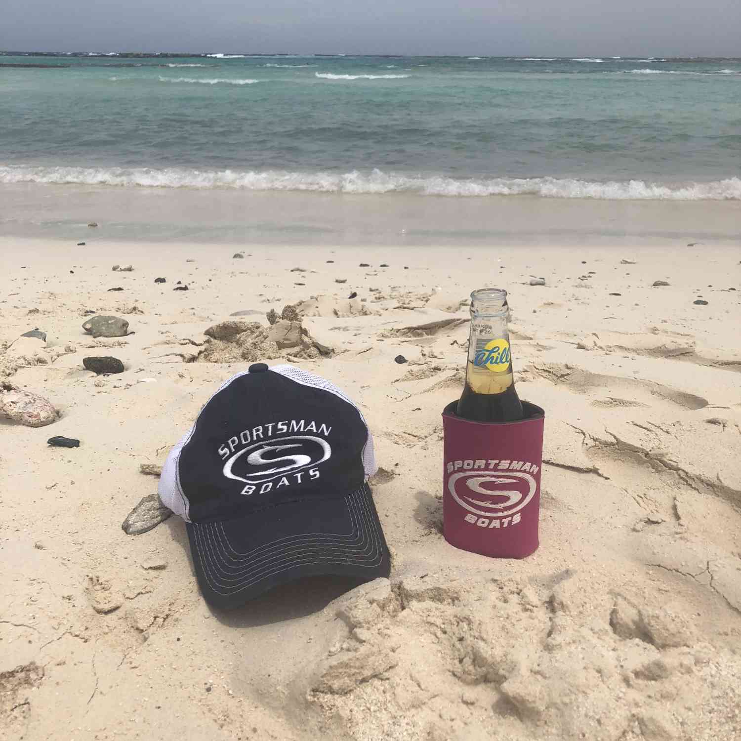 Hat and koozie on the beach in Aruba