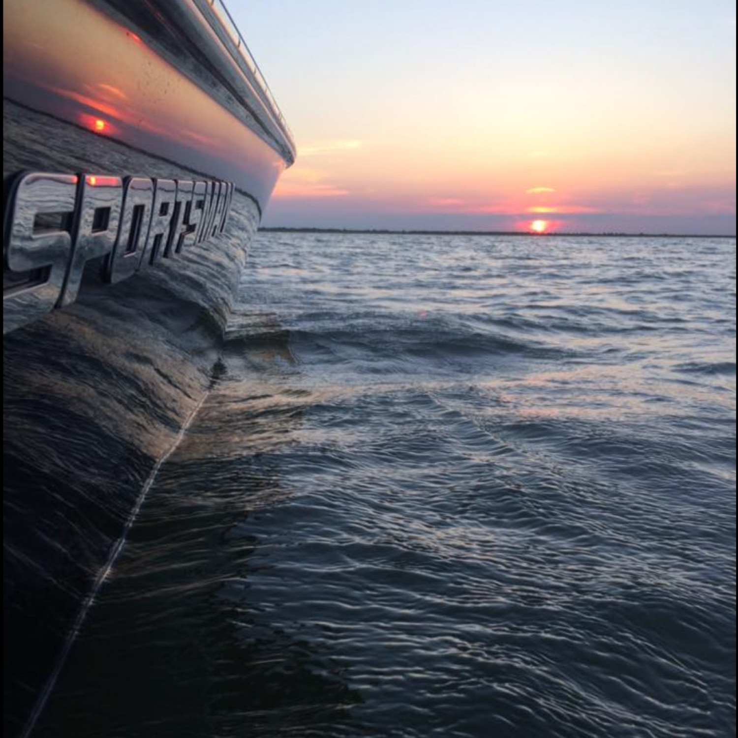 Finishing up fishing and was hanging over the side to wash off and saw the reflection of the sun in...