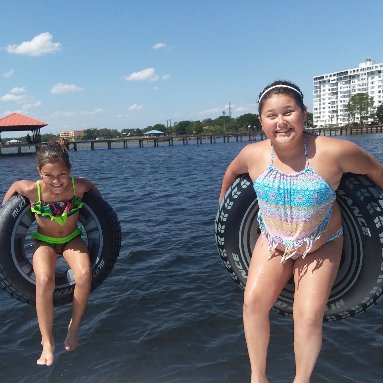 Kids jumping off the boat into the water