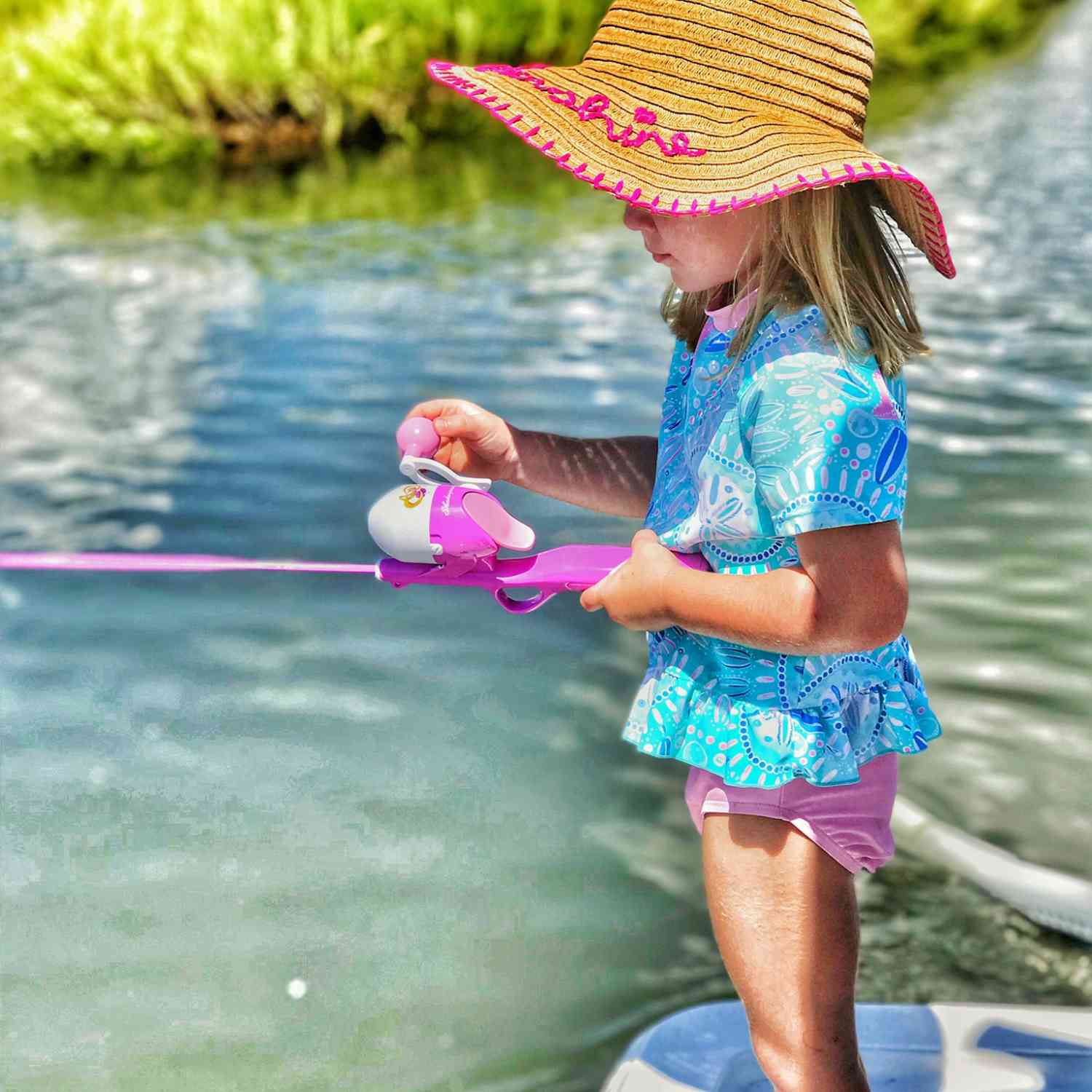 A 5 year old Little Girl who loves to out fish her daddy and brother with her pink fishing pole.