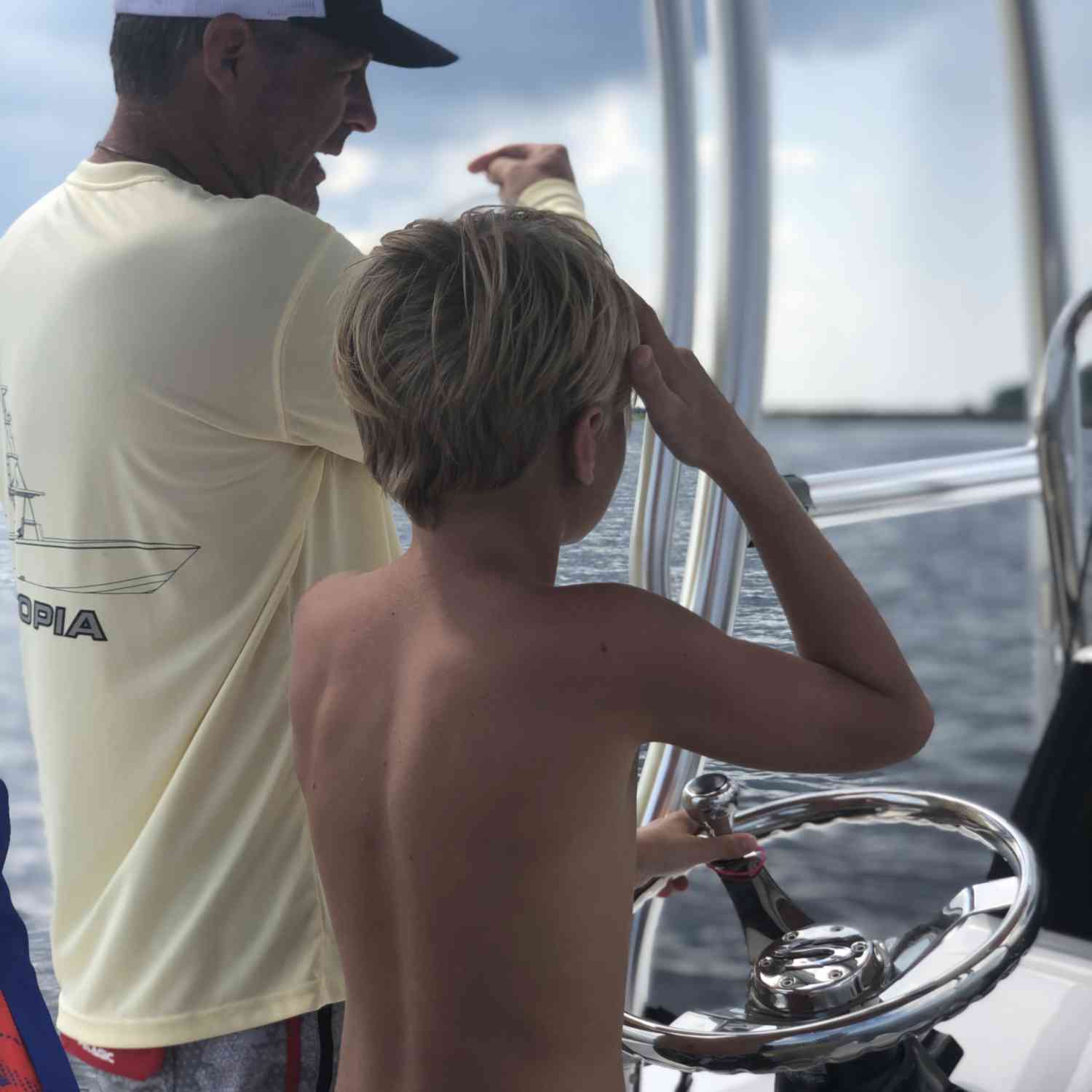 Daddy is teaching our 12 year old son to drive the boat!