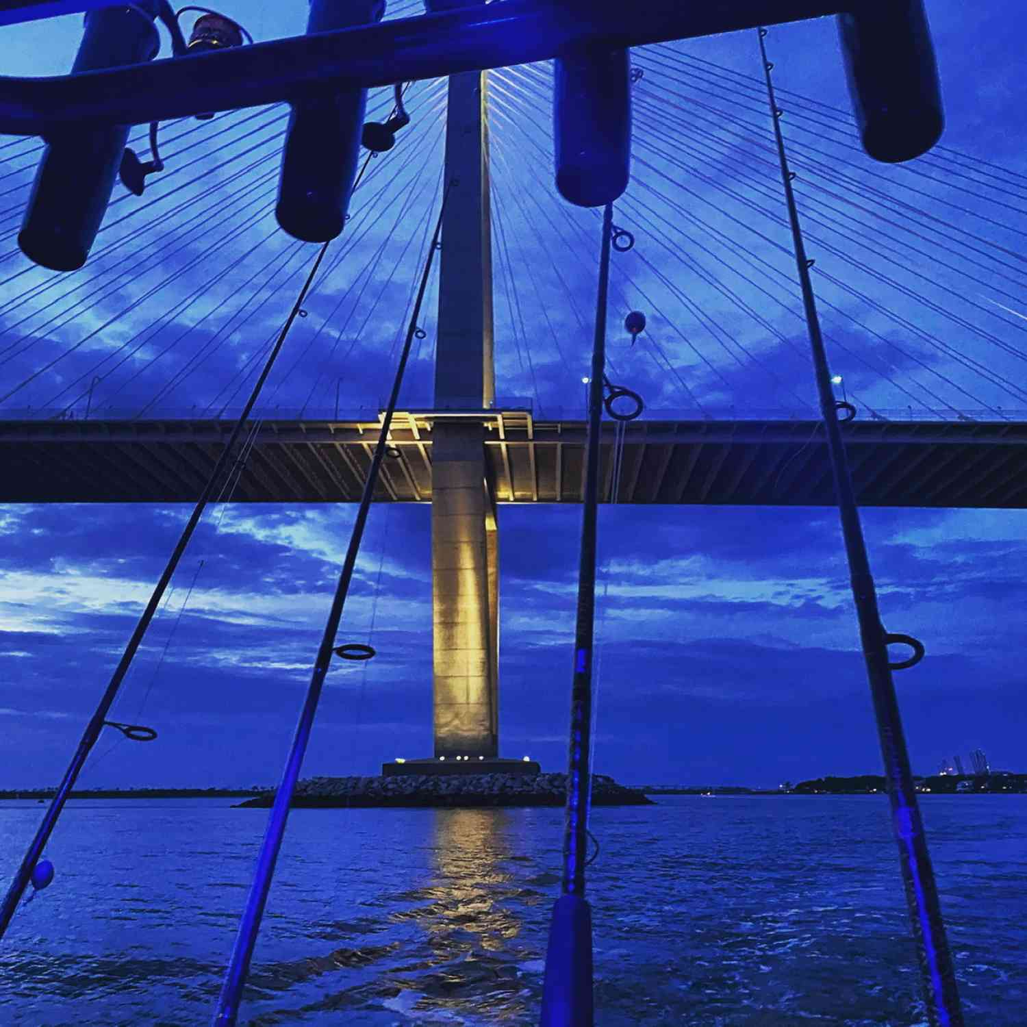 Blue courtesy lights illuminating the interior of the boat while the Ravenel shines in the background for some night fishing.