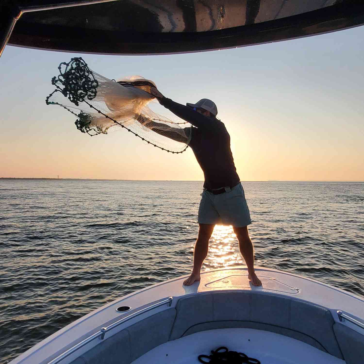 Bait casting for menhaden at sunrise for the days fishing trip.