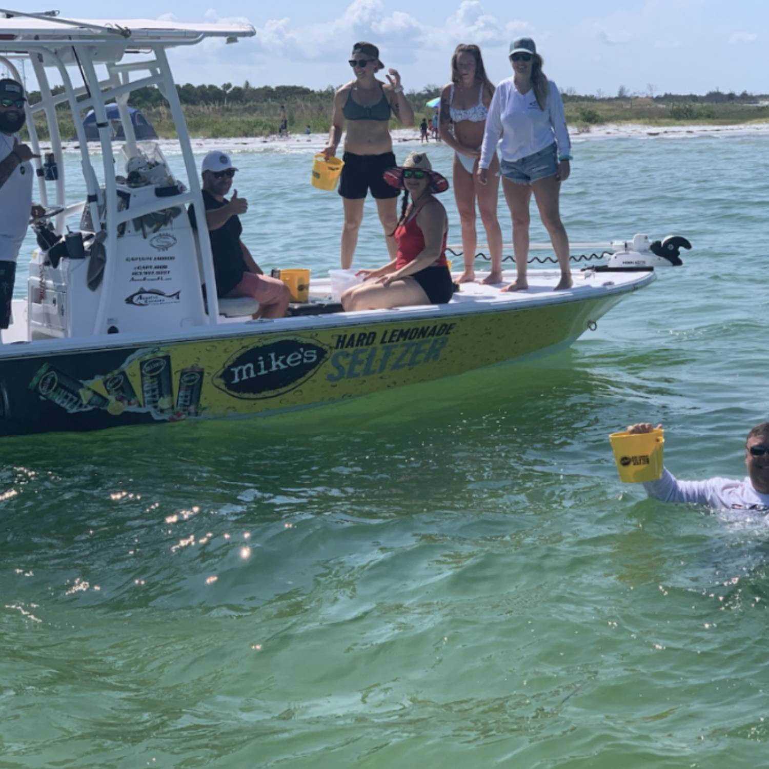 Beach day, giving away product to people at sandbar.