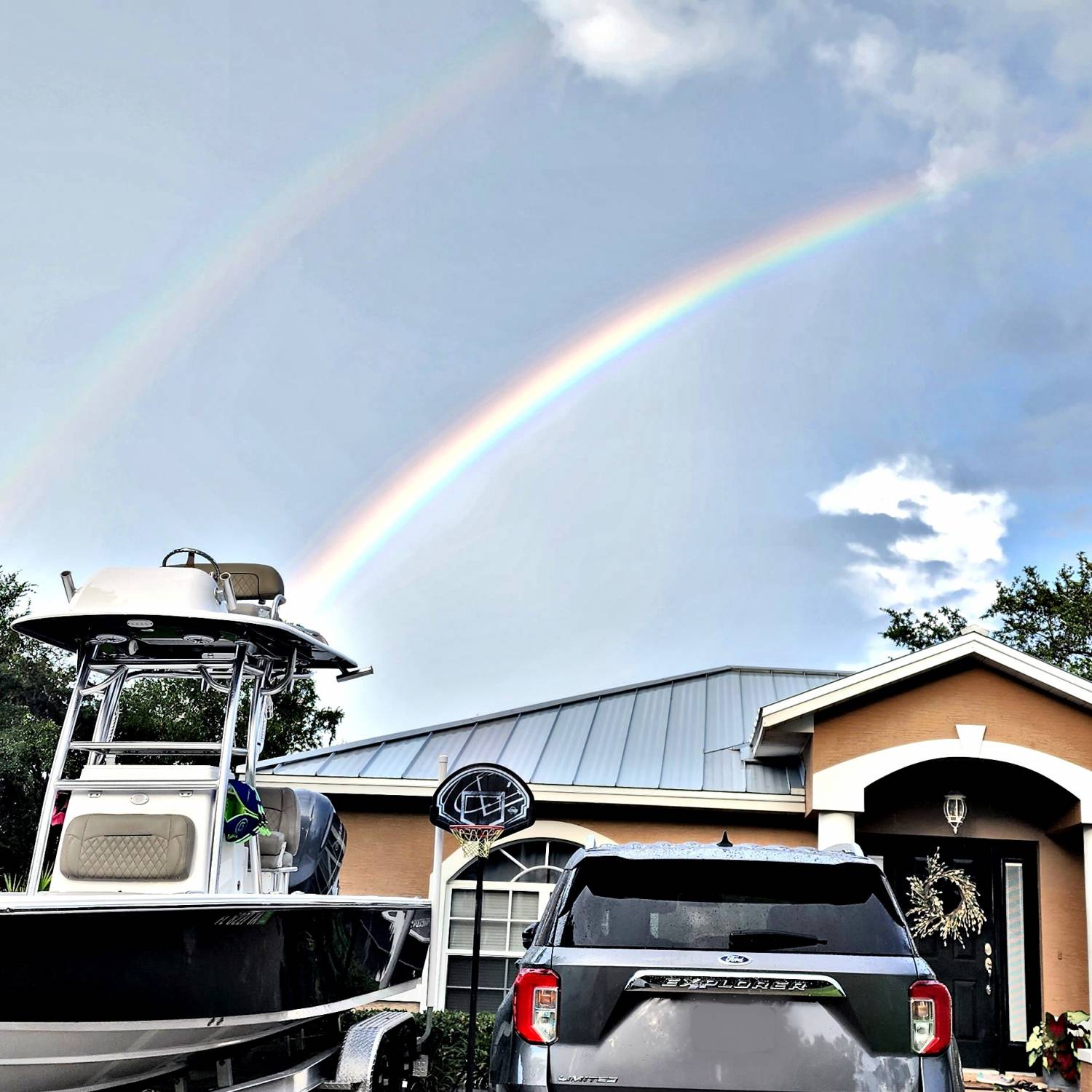 Title: Found what is at the end if the rainbow! - On board their Sportsman Masters 247OE Bay Boat - Location: Lake placid. Participating in the Photo Contest #SportsmanJuly