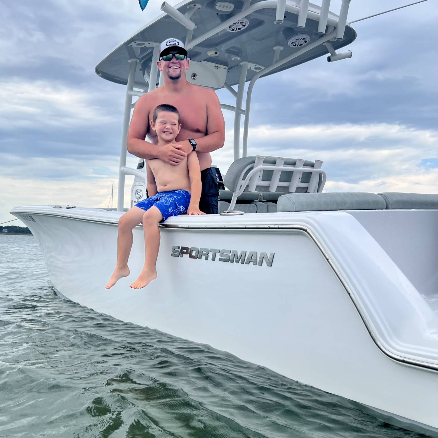 Dad and son (5 years old) enjoying a day at the sandbar catching minnows and crabs and showing off their...
