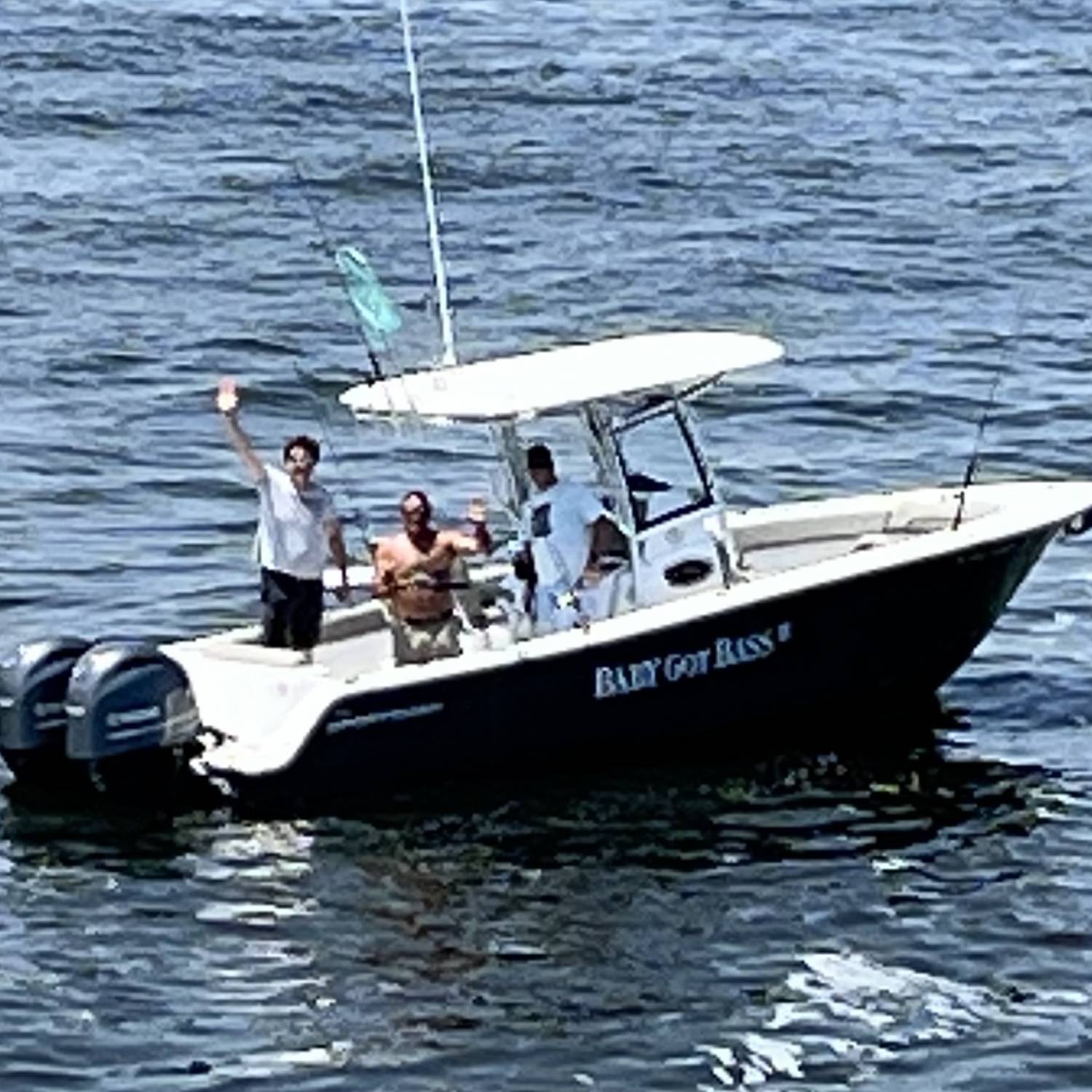 Fishing with my two friends while the Capt of the SeaStreak NY Ferry passes and takes this photo of us.