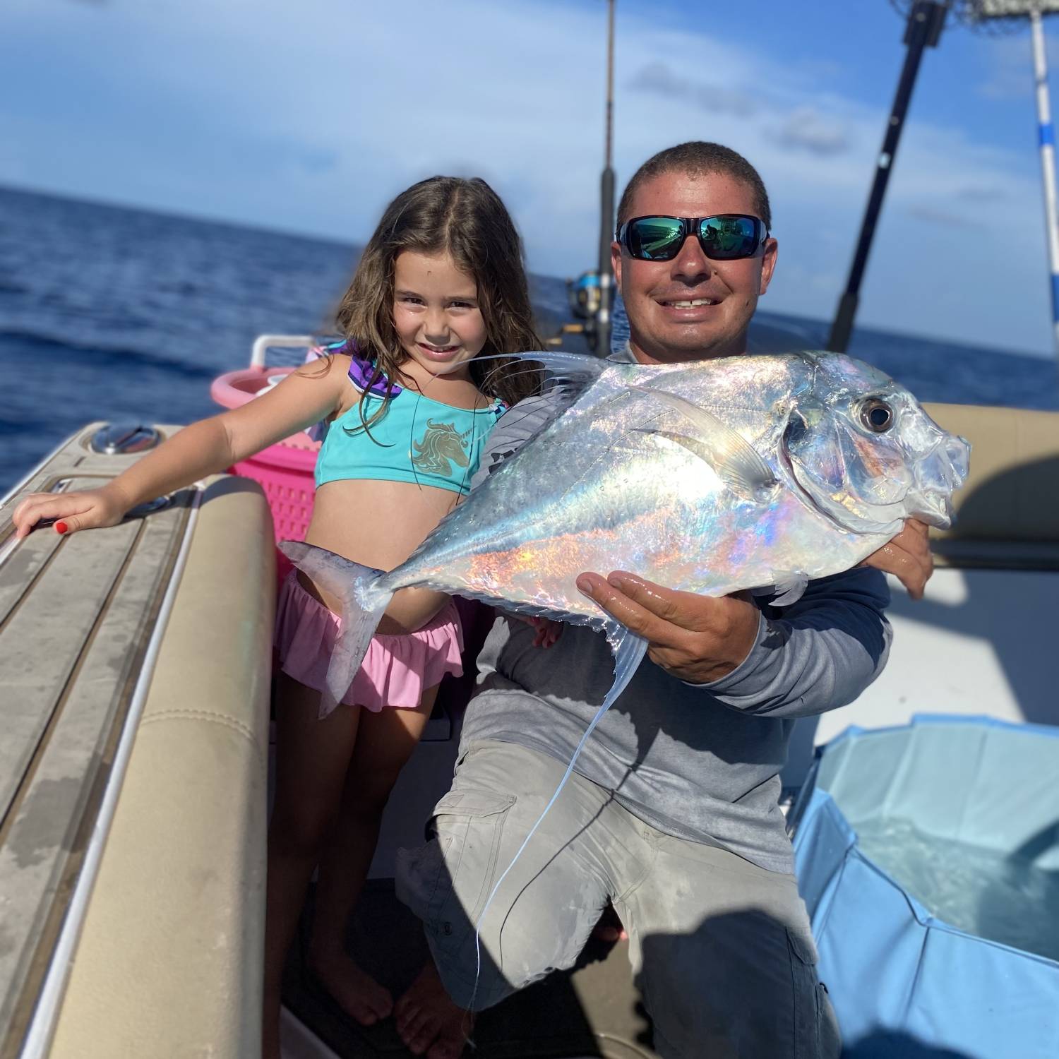 My husband, Tom and our daughter, Charlotte- 30 miles offshore catching African Pompano!