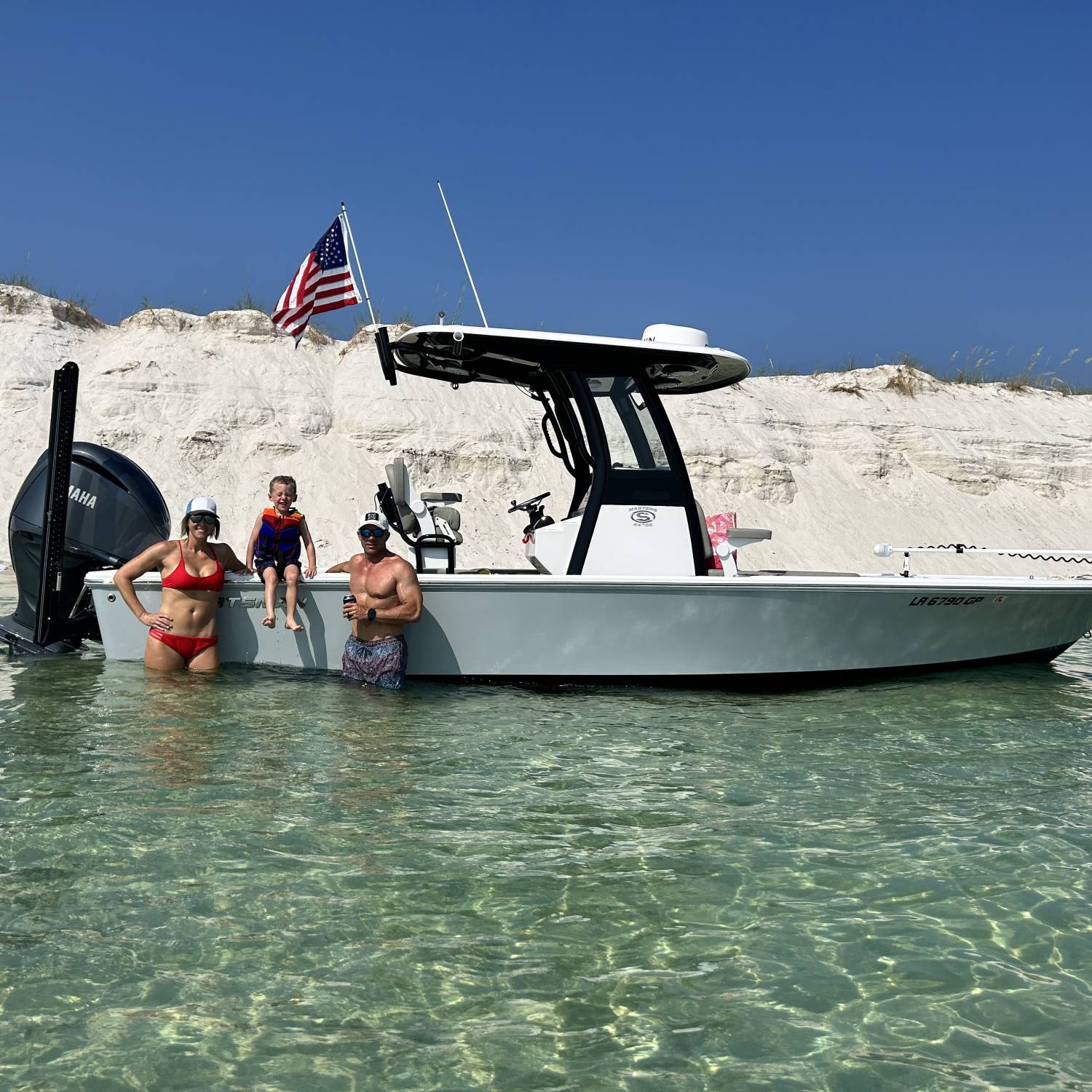 Family enjoying the day at the sand dunes near Fort McRae. This boat does it all