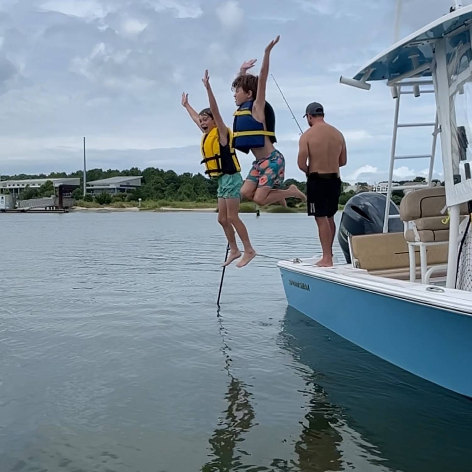 Two boys being boys. They love jumping off pop-pops boat at the sandbar.❤️